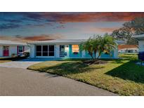 Charming single story home with teal accents and well-manicured lawn at 411 Circlewood Dr # I2, Venice, FL 34293