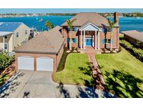 Brick house with two-car garage, waterfront property, nicely landscaped lawn at 708 Laguna Dr, Venice, FL 34285