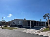 Charming single-story home with screened lanai and well-maintained landscaping, situated in a quiet community at 874 Baveno Dr, Venice, FL 34285