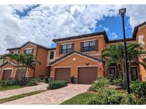 Attractive two-story townhome with two-car garage and lush landscaping at 20234 Lagente Cir, Venice, FL 34293