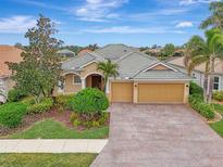 Single-Gathering home with a two-car garage and well-manicured landscaping at 2224 Mesic Hammock Way, Venice, FL 34292