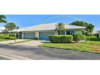 Exterior of a two-car garage villa with a landscaped yard at 3117 Heron Shores Dr, Venice, FL 34293