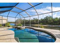 Relaxing screened-in pool and spa overlooking a serene waterway at 1206 Tuscany Blvd, Venice, FL 34292