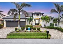 Stunning waterfront home with a modern design, landscaped yard, and a two-car garage at 1371 Grebe Dr, Punta Gorda, FL 33950
