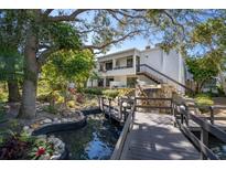 Beautiful two story condo featuring a serene water feature and lush landscaping at 1555 Tarpon Center Dr # 238, Venice, FL 34285