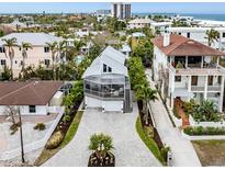 Aerial view of a house with a large driveway and ocean in the background at 176 Emerson Dr, Sarasota, FL 34236