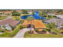 Aerial view of house near lake in a residential community at 1815 Killdeer Ct, Venice, FL 34293