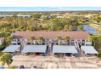 Aerial view of condo building, showing covered parking and landscaping at 200 Silver Lake Dr # 105, Venice, FL 34292