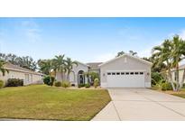 Single-story home with attached garage and landscaped lawn at 4004 Landor Ct, Venice, FL 34293