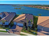 Aerial view of a single-Gathering home with lake access and community view at 629 Maraviya Blvd, Nokomis, FL 34275