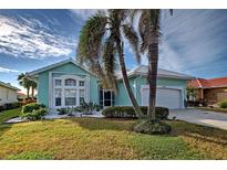 Single-story house with a two-car garage and landscaping at 660 Silk Oak Dr, Venice, FL 34293