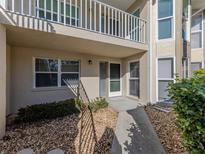 Exterior view of condo building with walkway, landscaping, and private entrance at 801 Waterside Dr # 102, Venice, FL 34285