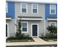 Modern two-story home with gray and blue exterior, walkway, and landscaping at 8545 Daybreak St, Sarasota, FL 34241