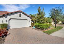 White garage door and paver driveway at 9824 Haze Dr, Venice, FL 34292