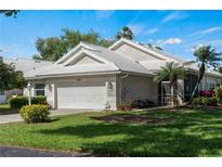 Single-story home with a white garage door and well-manicured lawn at 1523 Belfry Dr, Venice, FL 34292
