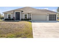 Single-story house with attached garage and landscaping at 2949 Jaylene Rd, North Port, FL 34288