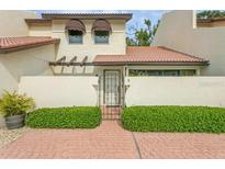 Front view of a charming condo with a terracotta roof and gated entryway at 440 Palmetto Ct # 3, Venice, FL 34285