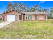 Charming ranch home with a white garage door and well-maintained lawn at 508 N Quincy Rd, Venice, FL 34293