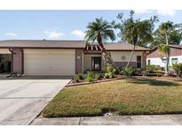 Cute two-bedroom villa with attached garage and landscaped yard at 664 Linden Dr, Englewood, FL 34223