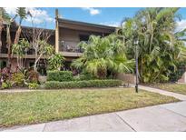 Front view of condo with landscaping and walkway at 958 Sunridge Dr # H3, Sarasota, FL 34234