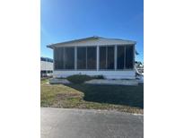 White single-wide manufactured home with screened porch at 199 Palm Air Dr, Osprey, FL 34229