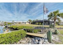 Private backyard with canal access and a wooden footbridge at 201 Villa Dr # 201, Osprey, FL 34229