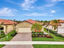 Single-Gathering home with a landscaped yard and brick driveway at 24165 Spartina Dr, Venice, FL 34293