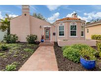 Charming Spanish-style home with tile roof, walkway, and well-manicured landscaping at 321 Pedro St, Venice, FL 34285