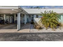 Inviting coastal home with carport, walkway, and landscaped yard at 335 Englewood Isles Pkwy # 55, Englewood, FL 34223