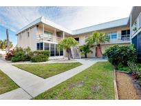 Two-story condo building with landscaped grounds and walkway at 460 Base E Ave # 122, Venice, FL 34285