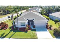 Single-story house with gray roof, screened porch, and landscaped yard at 4940 Thames Ln, Sarasota, FL 34238