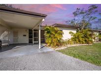Tan exterior house with carport and tropical landscaping at 6246 Green View Cir # 97, Sarasota, FL 34231