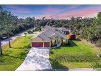 Beautiful single-story home featuring a well-maintained lawn and a spacious driveway at 2737 Cottage Ln, North Port, FL 34286