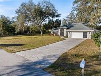 Single-story home with a large yard and driveway at 337 Flamingo Blvd, Port Charlotte, FL 33954