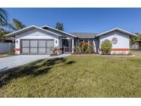 Single-story home with attached garage and well-manicured lawn at 4060 Barbary Ln, North Port, FL 34287