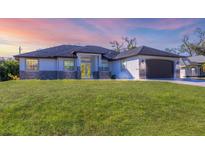 Single-story home with a dark brown garage door and nicely landscaped lawn at 4363 Hamwood St, North Port, FL 34287