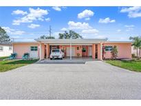 Cute pastel pink exterior with carport and small yard at 6213 Green View Dr # 127, Sarasota, FL 34231