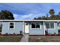 Newly renovated light blue house with landscaped yard at 8500 Agress Ave, North Port, FL 34287