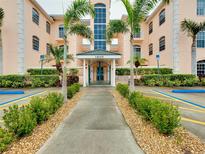 Inviting condo building entrance with lush landscaping and walkway at 1602 Gondola Park Dr # 1602, Venice, FL 34292