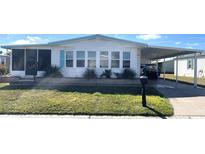 Charming single-story home with a covered carport and well-maintained lawn at 346 Mariner Dr, North Port, FL 34287