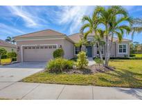 Charming single-Gathering home features a tile roof, well-manicured lawn, and lush tropical landscaping at 357 Marsh Creek Rd, Venice, FL 34292