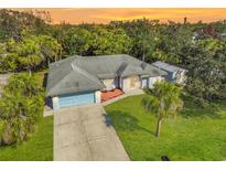 Single-story house with a large yard, driveway, and two-car garage at 740 Citrus Rd, Venice, FL 34293