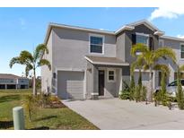 Charming two-story townhome with attached garage and well-maintained landscaping at 8955 Milestone Dr, Sarasota, FL 34238