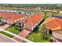 Aerial view of a community featuring several homes with tile roofs and landscaped yards at 10117 Colubrina Dr, Venice, FL 34293