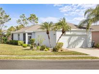 Charming single-story home with well-maintained lawn and landscaping and a two car garage at 11915 Tempest Harbor Loop, Venice, FL 34292