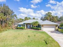 Well-maintained single-story home with lush landscaping, lawn, and charming curb appeal at 1232 Marilyn Ln, North Port, FL 34286