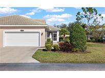 Charming home featuring a manicured lawn and a convenient two-car garage at 1537 Monarch Dr, Venice, FL 34293