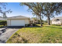 Charming single-story home with a well-maintained lawn and mature landscaping at 174 Southampton S Pl # 345, Venice, FL 34293