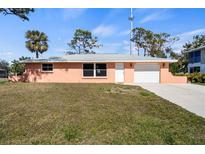 Charming single-story home with a well-maintained lawn and a two-car garage at 200 Pameto Rd, Nokomis, FL 34275