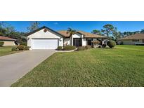 Charming single story home with a two car garage and well manicured lawn and mature landscaping at 302 Woodingham Ct, Venice, FL 34292